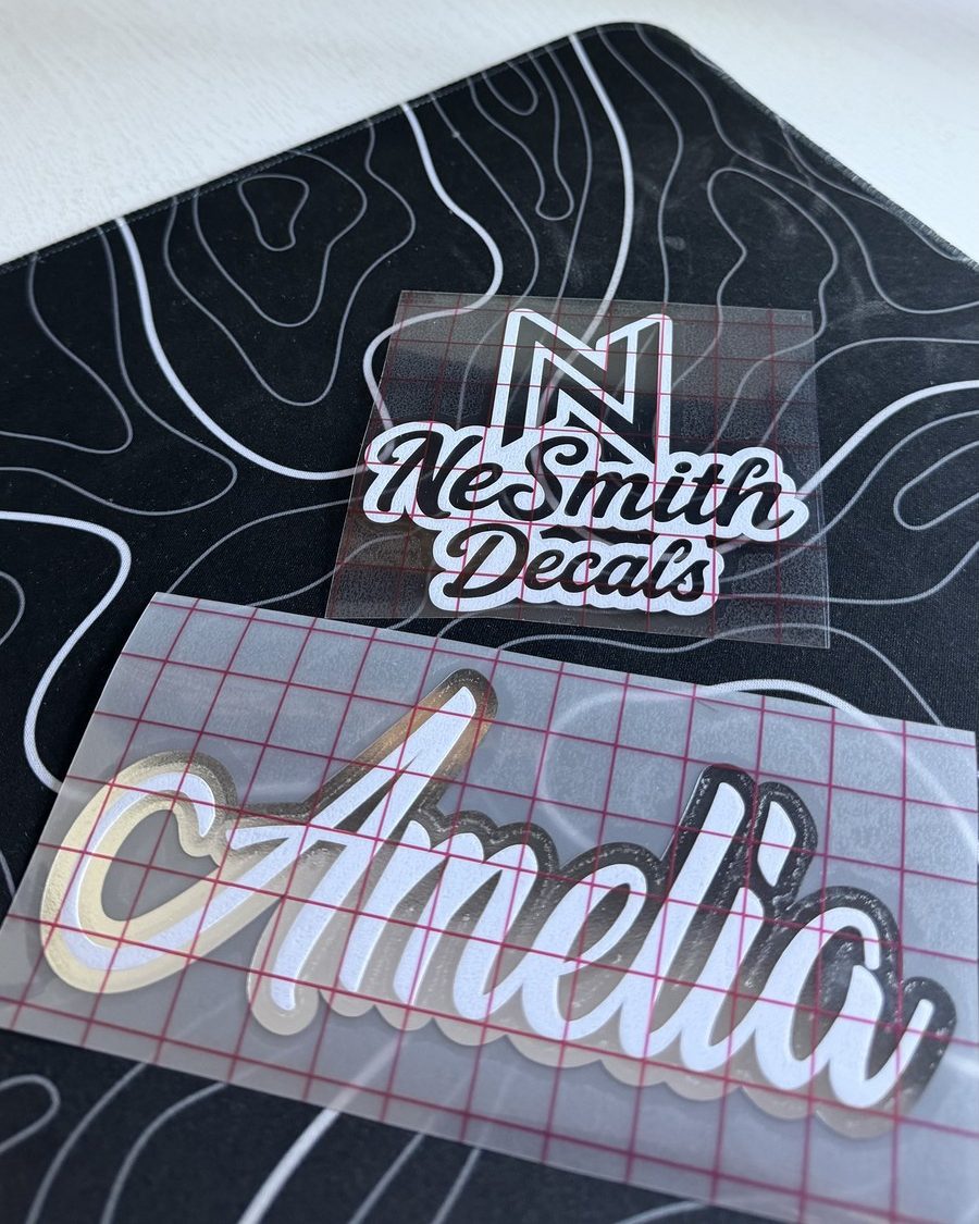 Two-layer script name decal in white with a chrome outline, on transfer tape