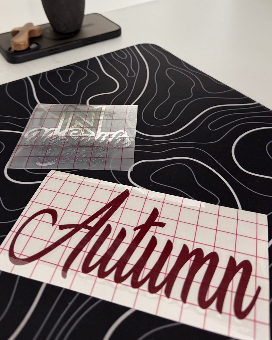 Maroon script name decal on transfer tape