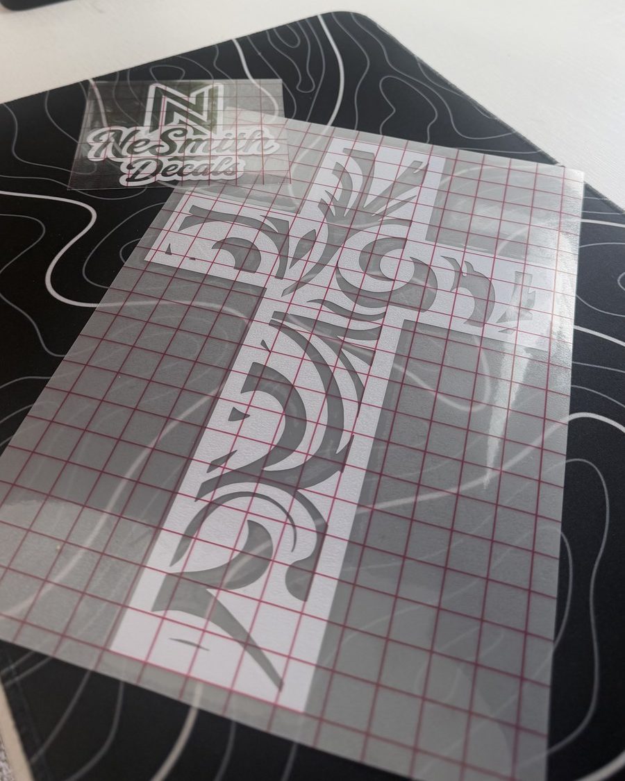 White ornate tooled cross decal on transfer tape