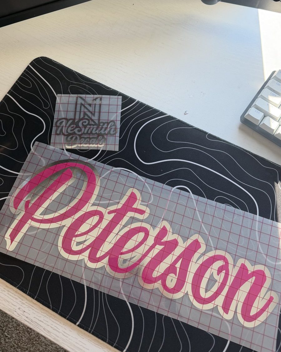 Hot pink script last-name decal with a cream and chrome outline, on transfer tape