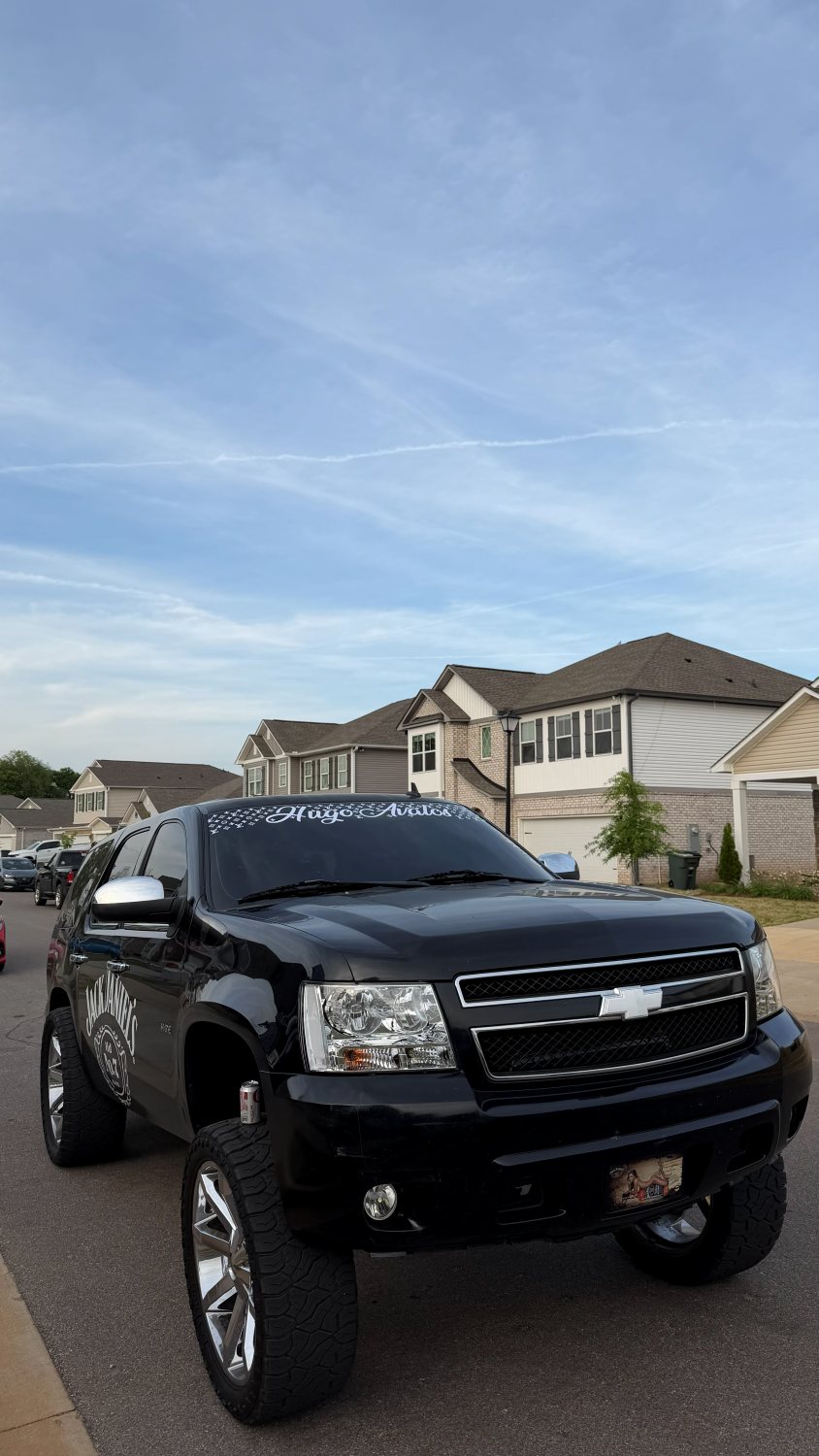 Hugo Avalos windshield name script on a lifted black Tahoe