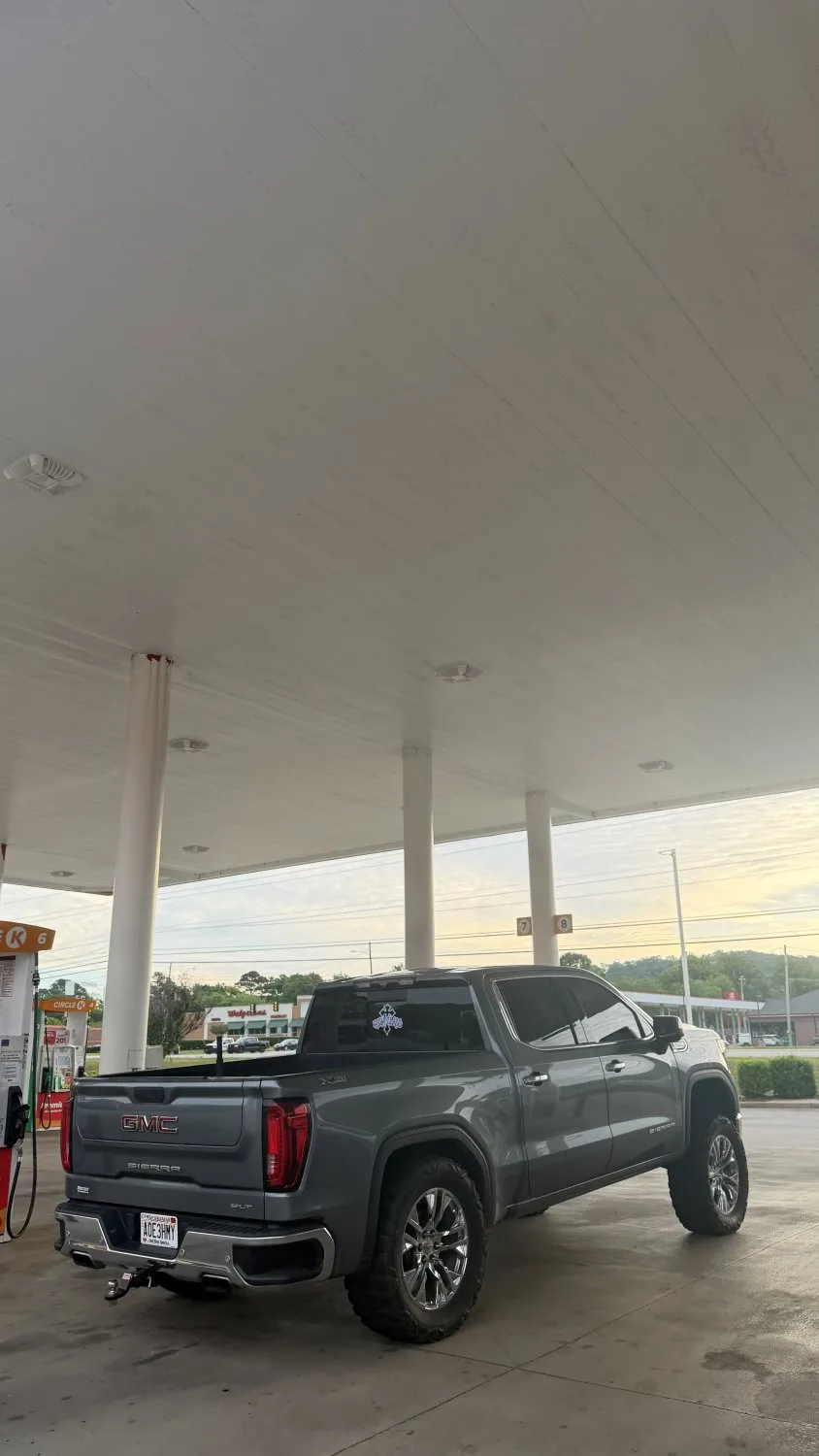 Gothic back-glass decal on a grey GMC Sierra at golden hour