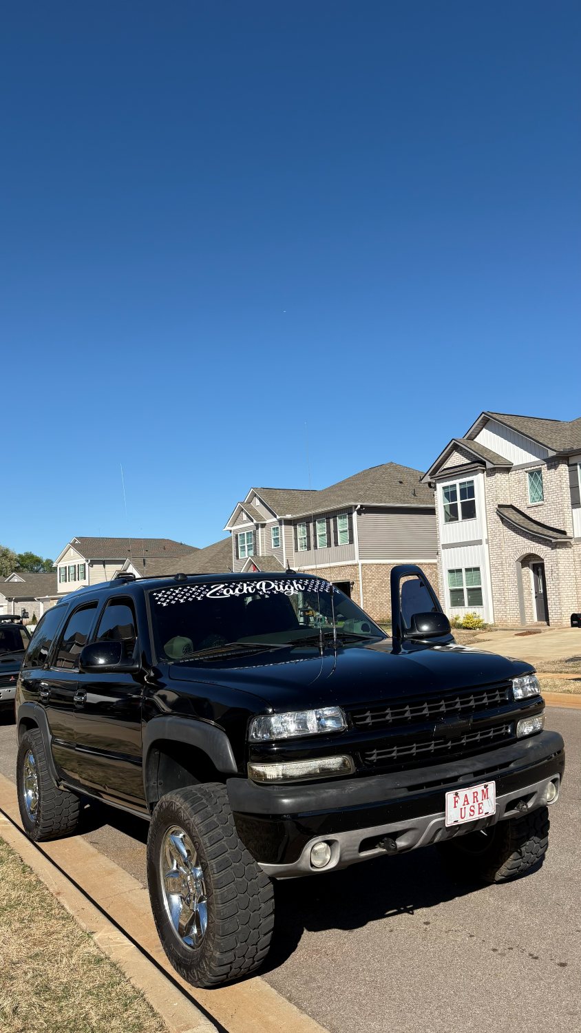 Windshield name banner on a lifted black Tahoe